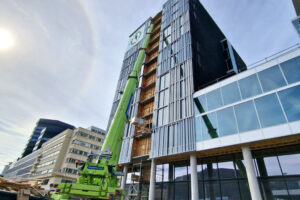 Green crane in front of a Big building (Bergen County Hall)