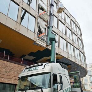 Cranetruck hoisting material delivery onto the Liftroller Floor by Crane Operator Alexander Meland at Sviland Transport AS