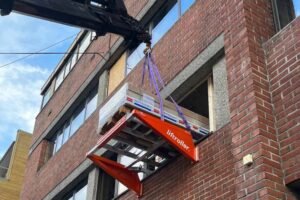 Package of Plaster boards rolling into the building on the Liftroller Wall