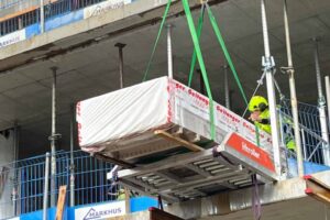 Package of drywall sheets rolled into the building using Liftroller Floor