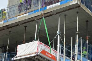 Package of drywall sheets rolled into the building using Liftroller Floor